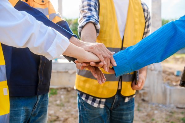 A close-up of hands joined together in unity, symbolizing teamwork, collaboration, shared success