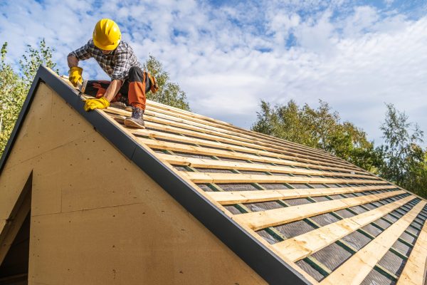 Professional Caucasian Construction Worker Wearing Hard Hat Assembling Roof Wooden Elements